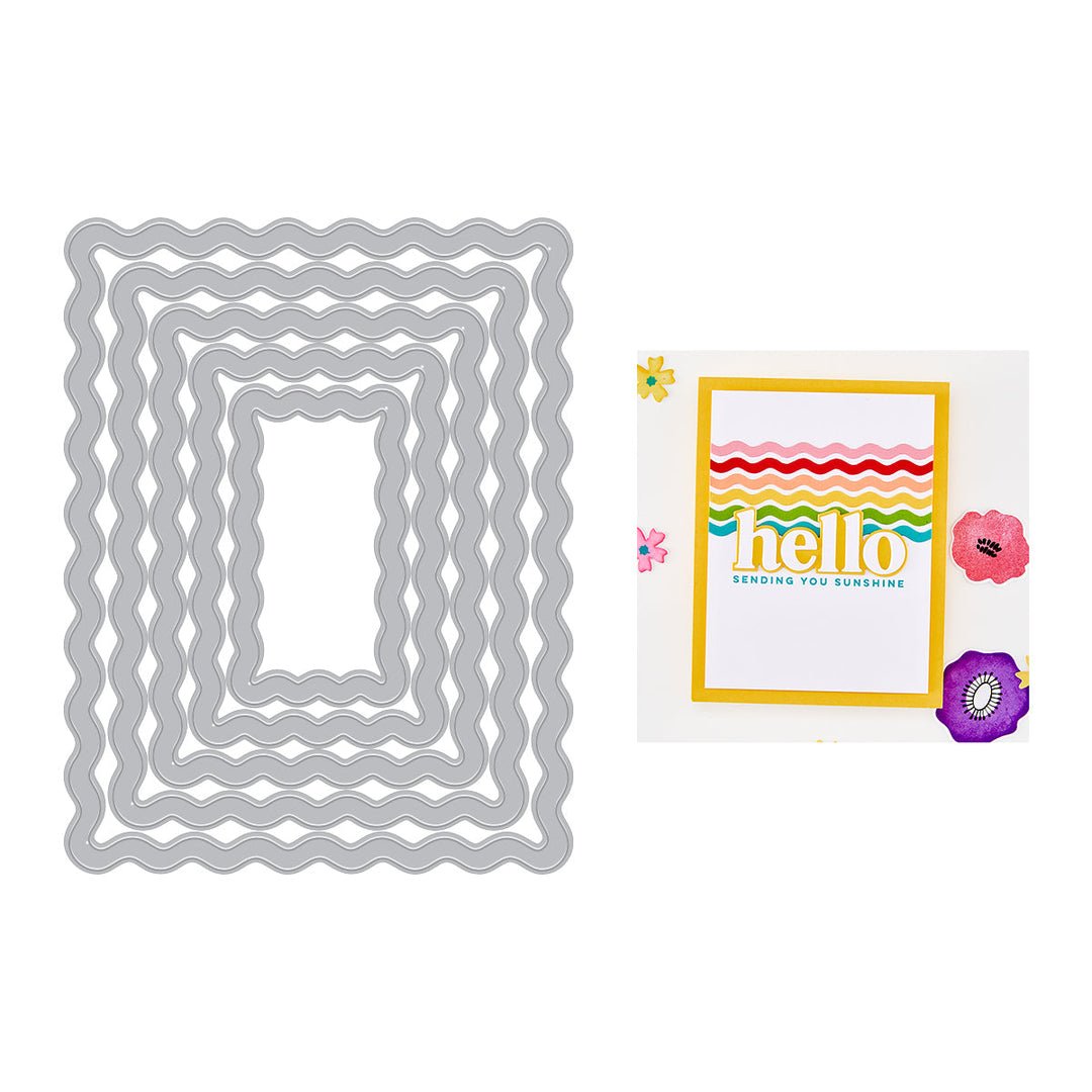 Set of metal dies and card with 'hello' sentiment and flowers on a white background.