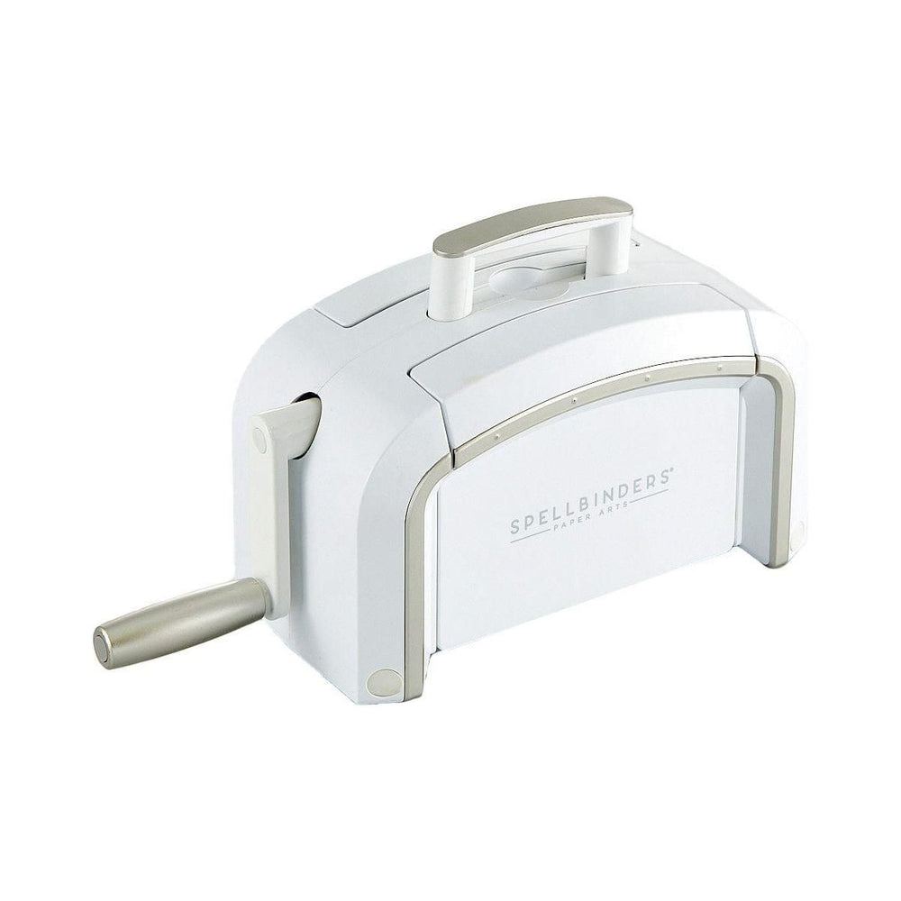 A Platinum SIX die cutting and embossing machine with a Universal Plate System. The machine is white with brushed platinum trim, next to a crafted card and additional embossing folders.